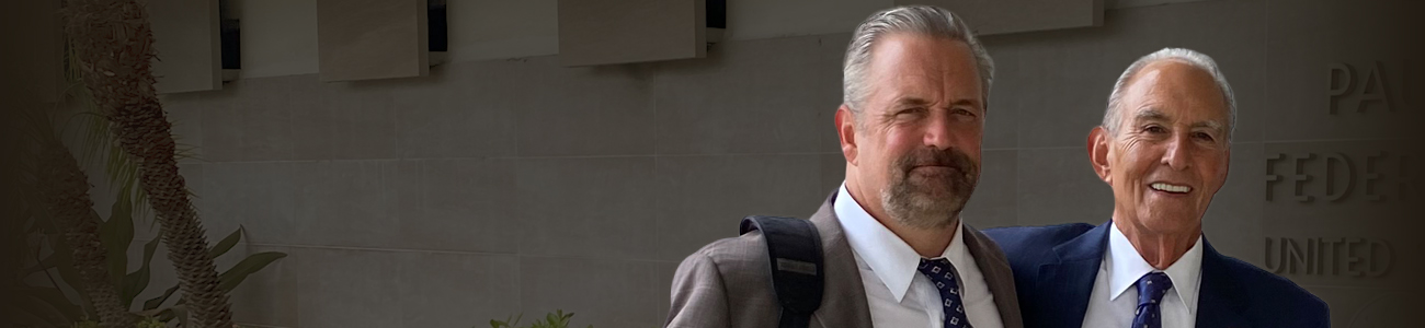 Philip C. Johnston and Glenn R. Roderman standing in front of a government building.